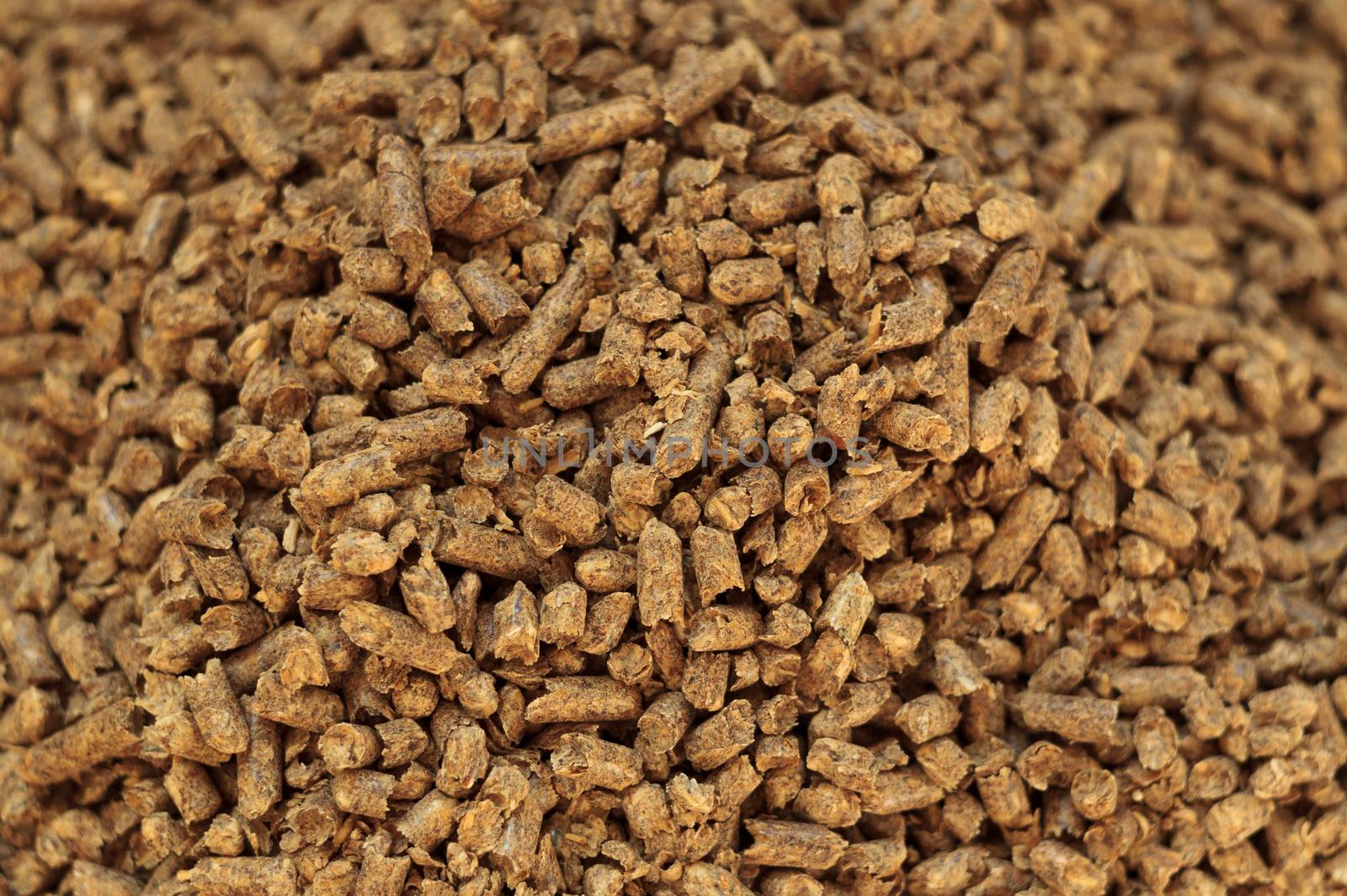 Fuel wood pellet close-up. A source of alternative clean energy. A lot of pellet. Natural fuel and energy of future.