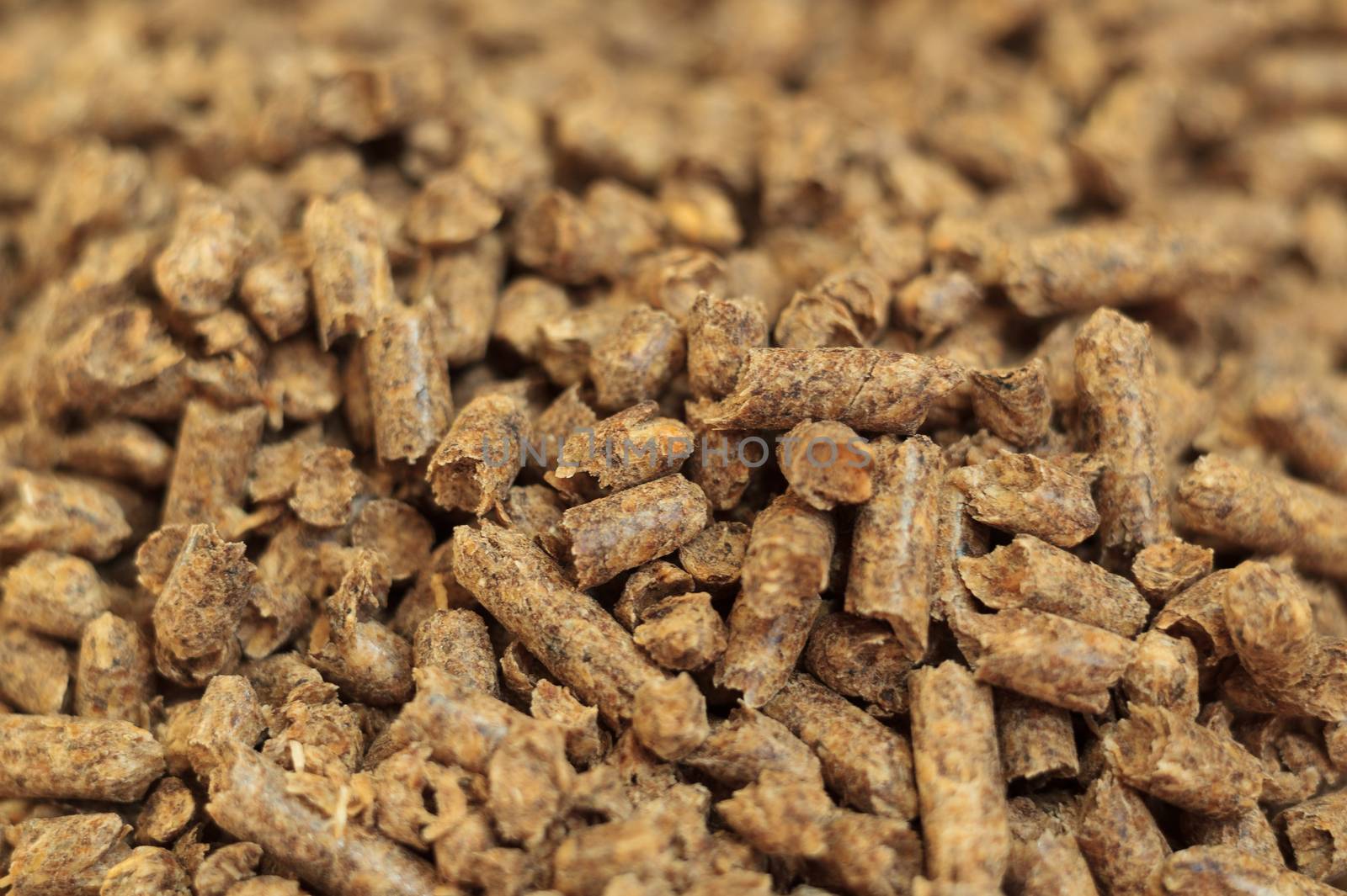 Fuel wood pellet close-up. A source of alternative clean energy. A lot of pellet. Natural fuel and energy of future.