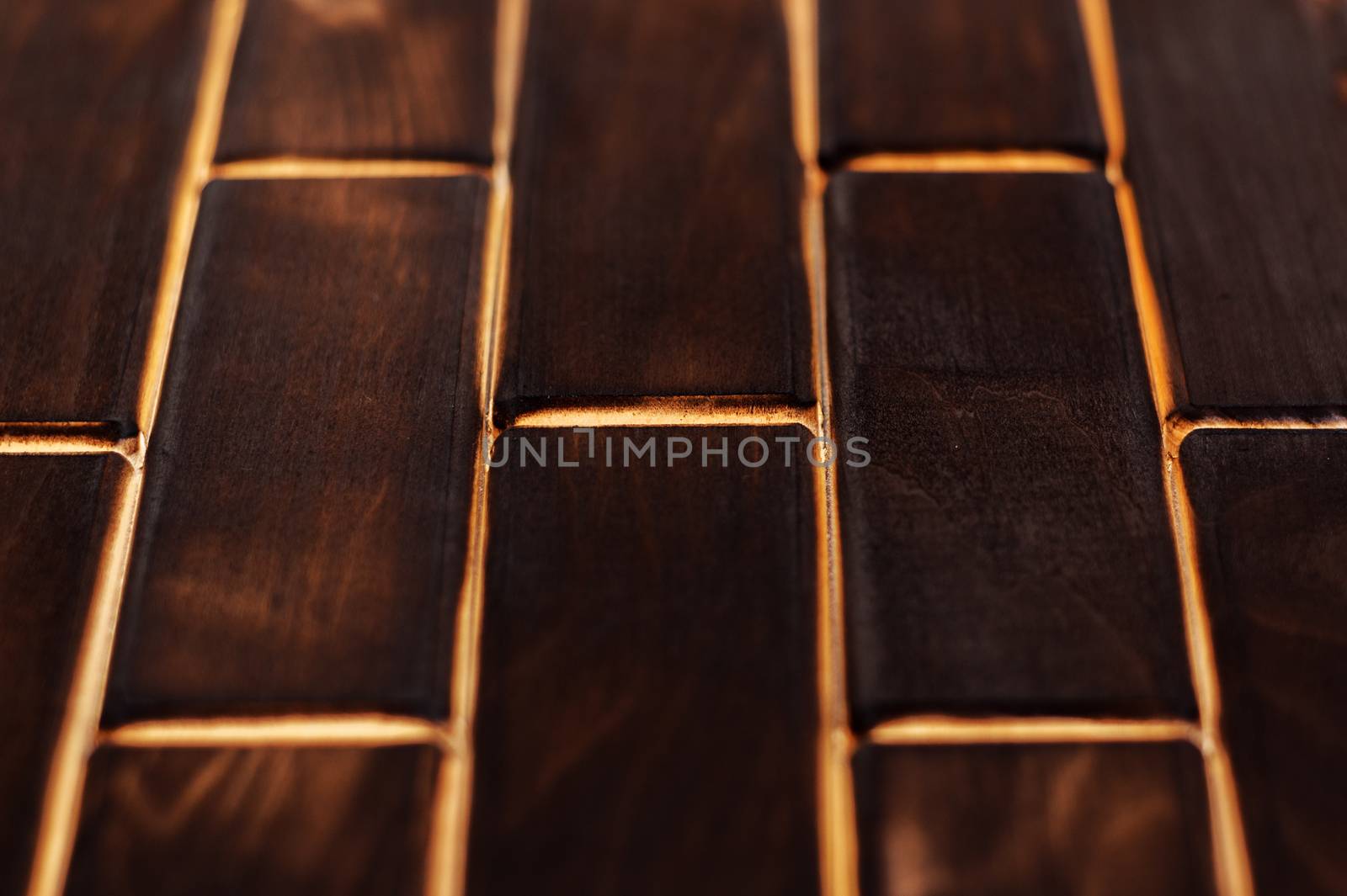 Wooden charred floor of small plates. Bottom view. Floor as an element of the interior.