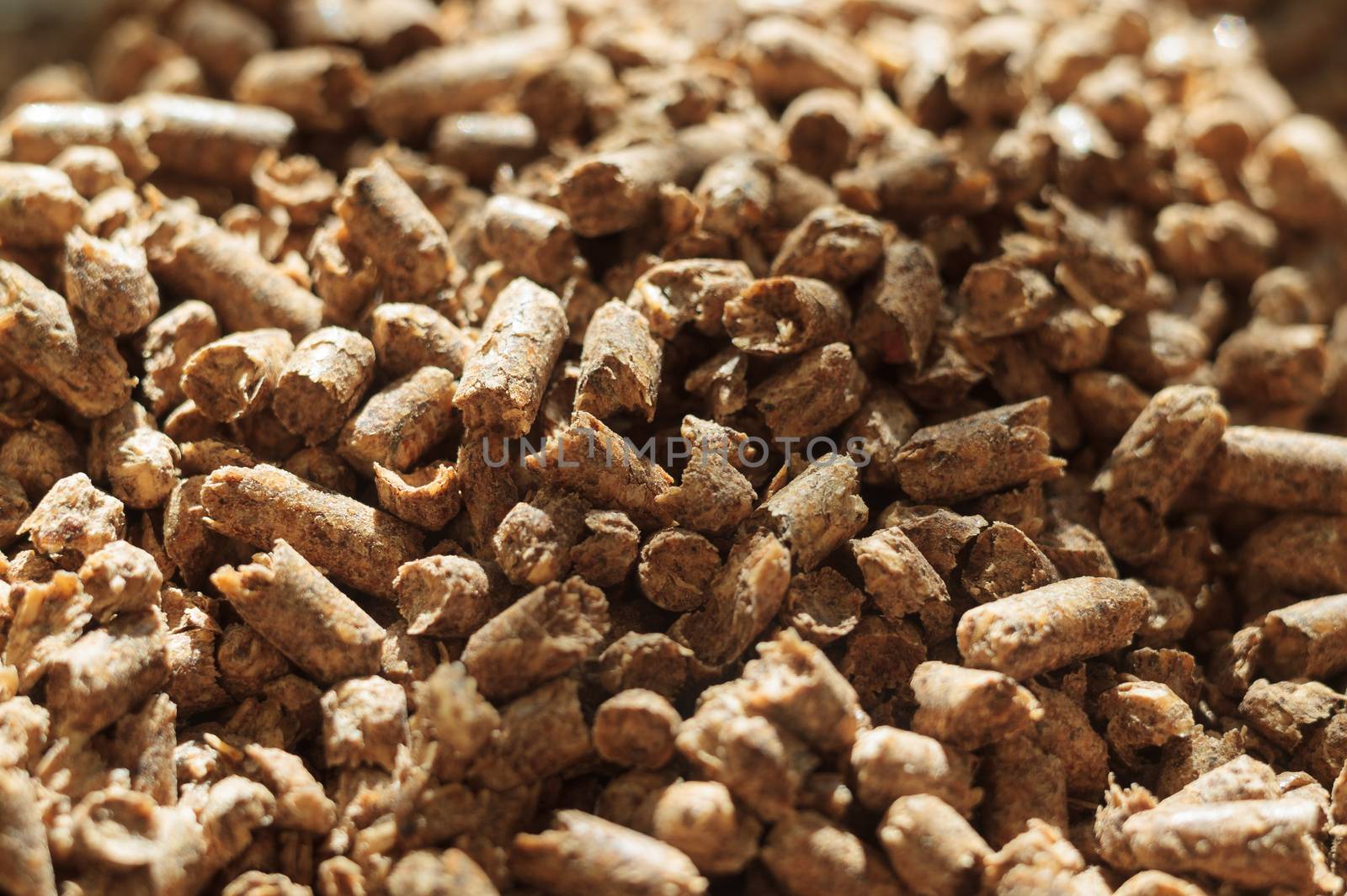 Fuel wood pellet close-up. A source of alternative clean energy. A lot of pellet. Natural fuel and energy of future.