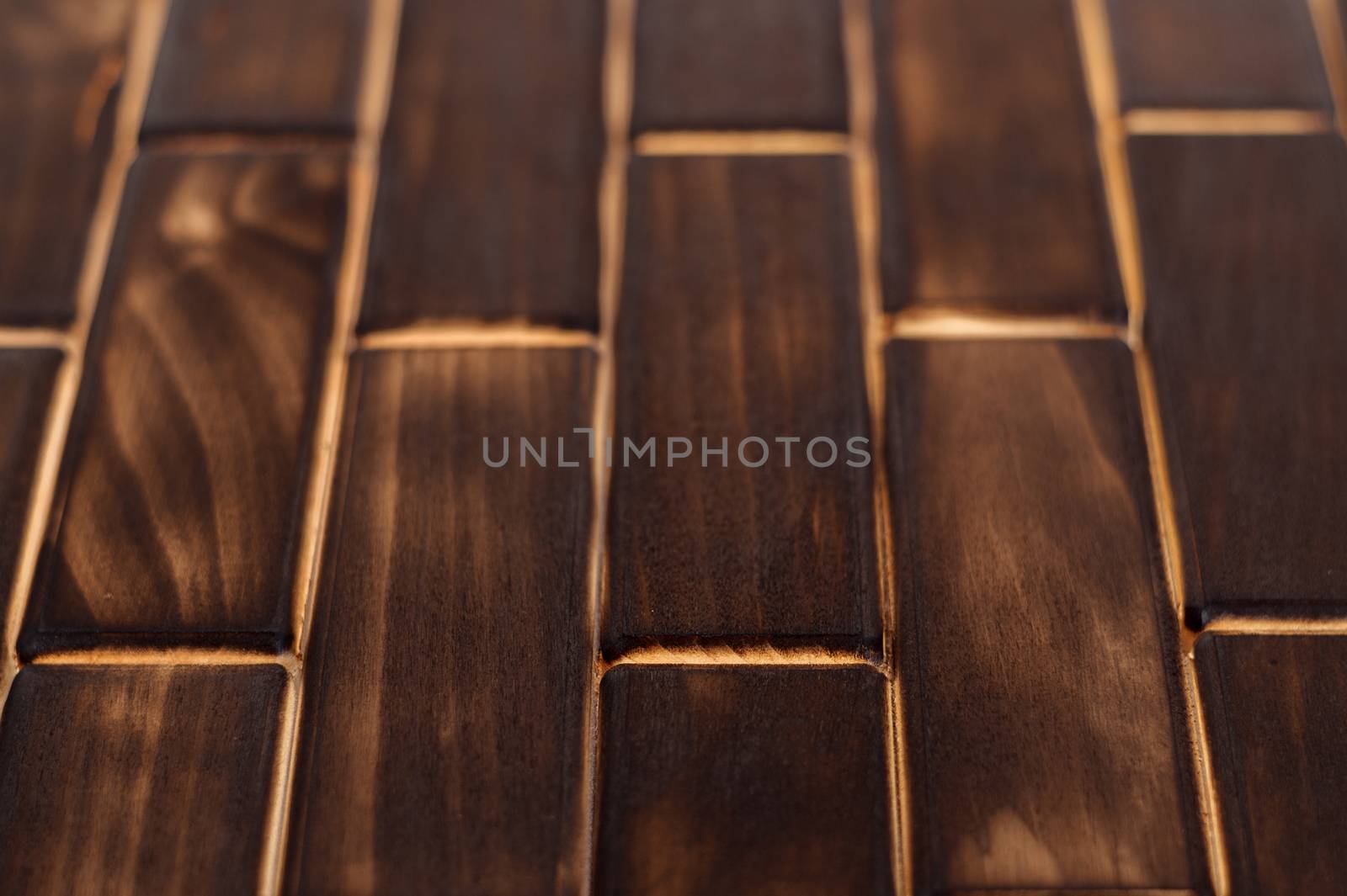 Wooden charred floor of small plates. Bottom view. Floor as an element of the interior.