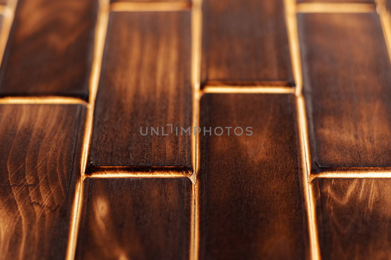 Wooden charred floor of small plates. Bottom view. Floor as an element of the interior.