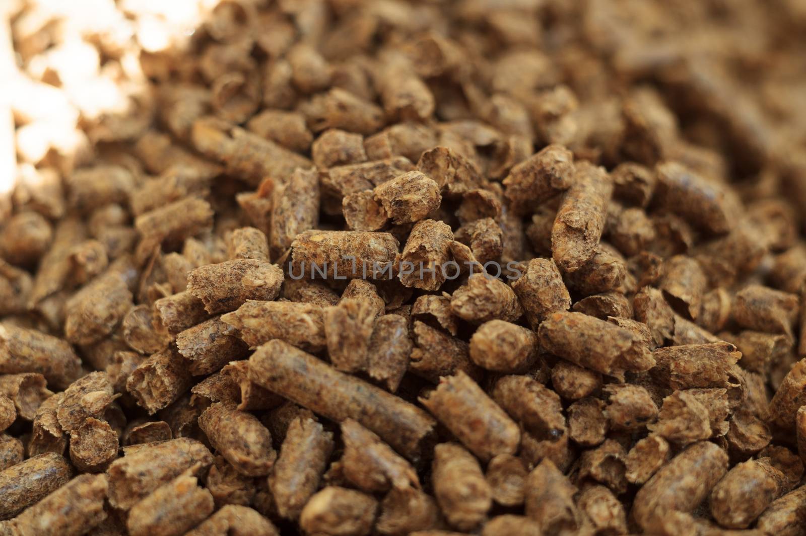 Fuel wood pellet close-up. A source of alternative clean energy. A lot of pellet. Natural fuel and energy of future.