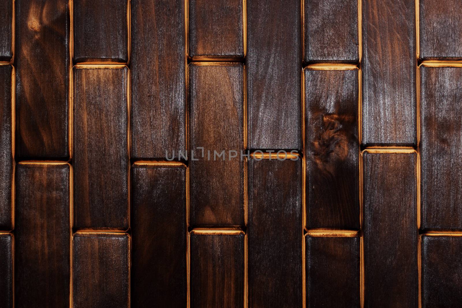 Wooden charred floor of small plates. View from above. Floor as an element of the interior.