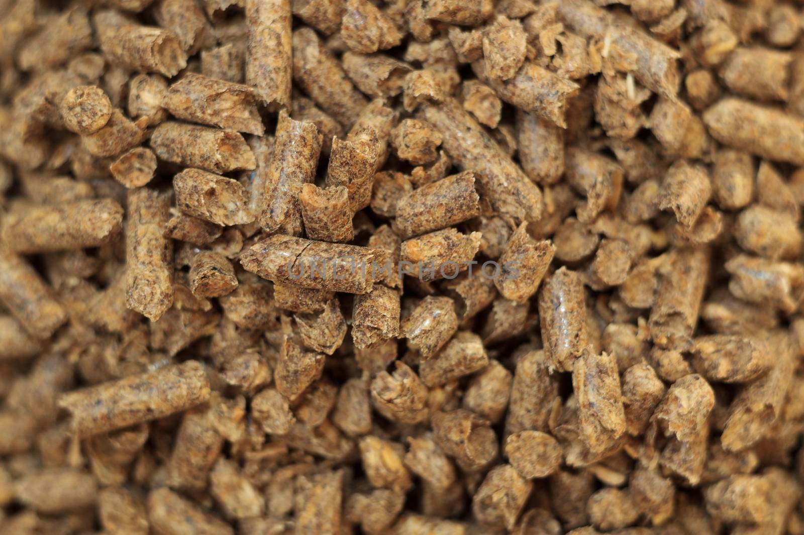 Fuel wood pellet close-up. A source of alternative clean energy. A lot of pellet. Natural fuel and energy of future.