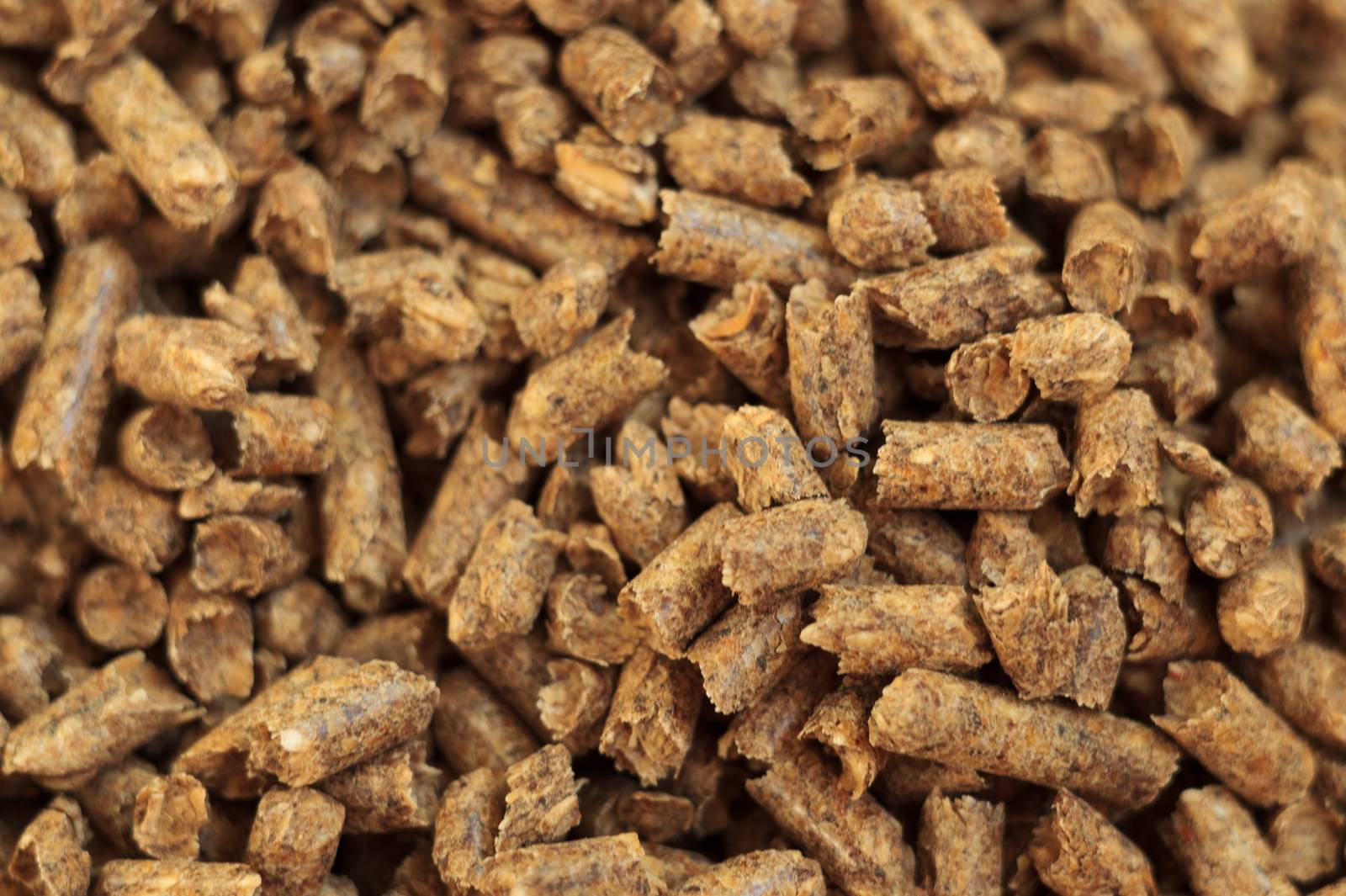 Fuel wood pellet close-up. A source of alternative clean energy. A lot of pellet. Natural fuel and energy of future.