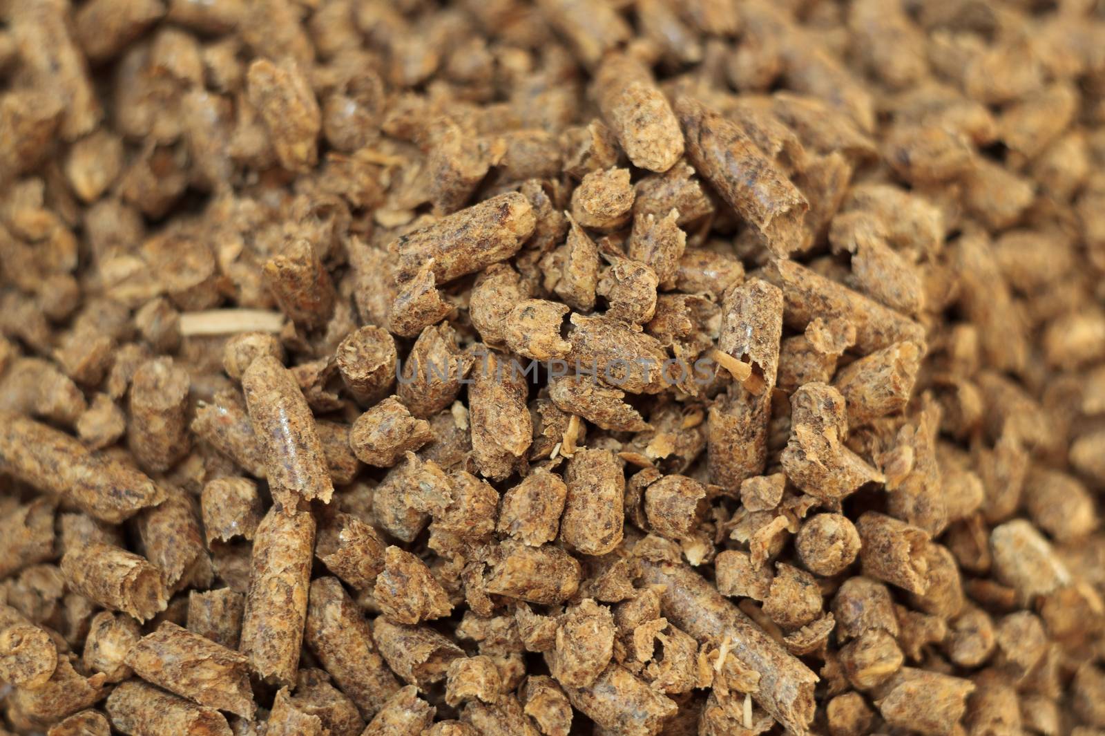 Fuel wood pellet close-up. A source of alternative clean energy. A lot of pellet. Natural fuel and energy of future.
