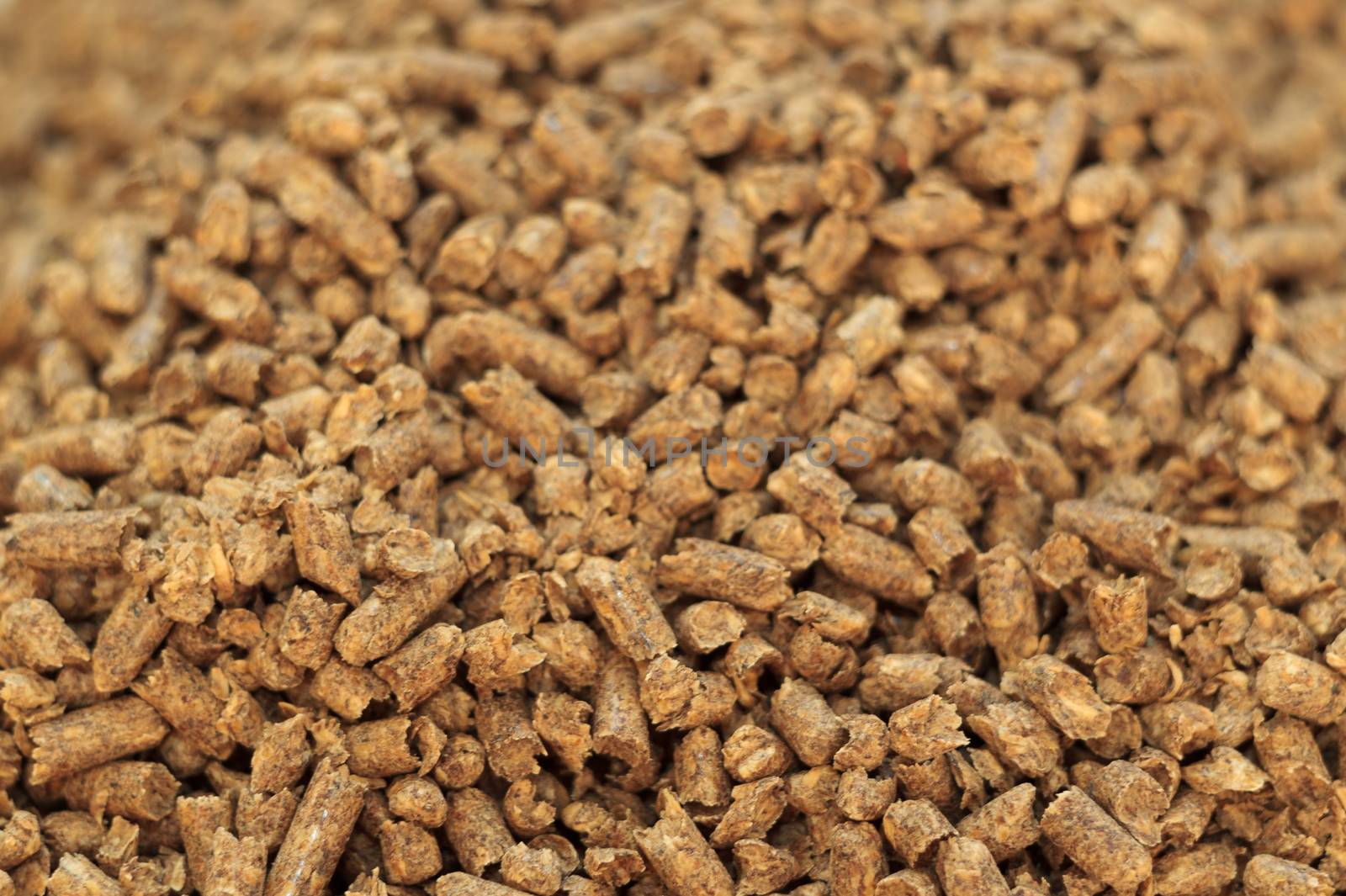 Fuel wood pellet close-up. A source of alternative clean energy. A lot of pellet. Natural fuel and energy of future.