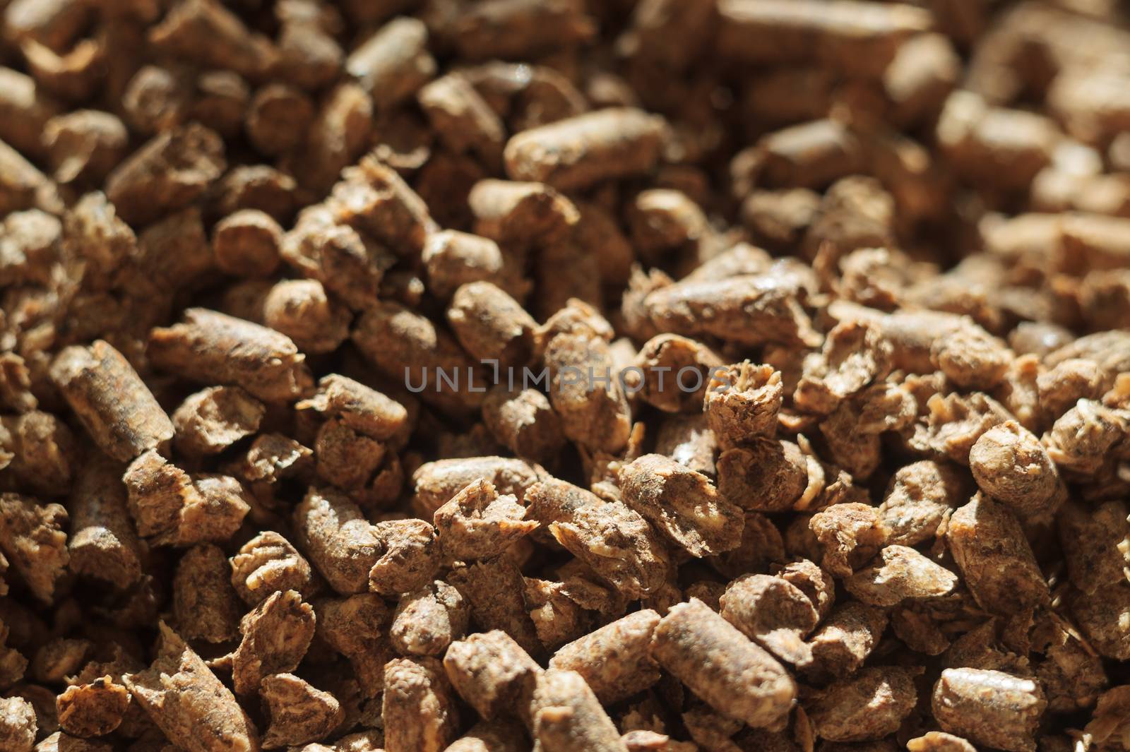 Fuel wood pellet close-up. A source of alternative clean energy. A lot of pellet. Natural fuel and energy of future.