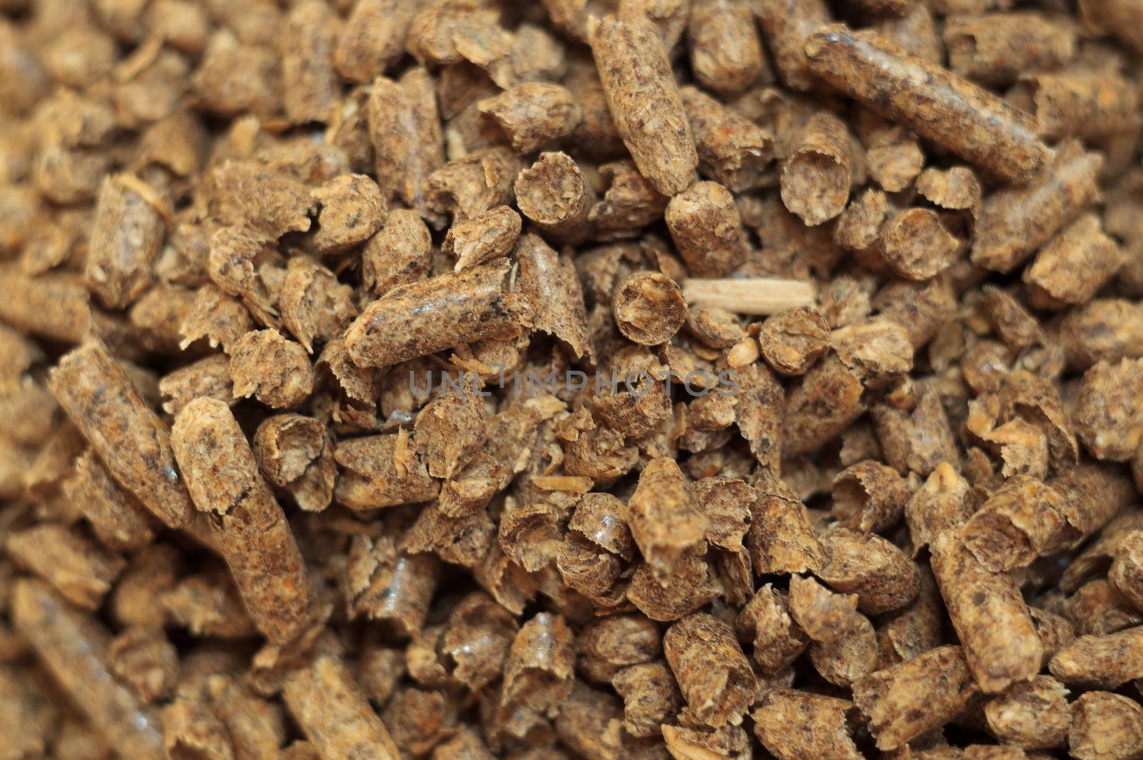 Fuel wood pellet close-up. A source of alternative clean energy. A lot of pellet. Natural fuel and energy of future.