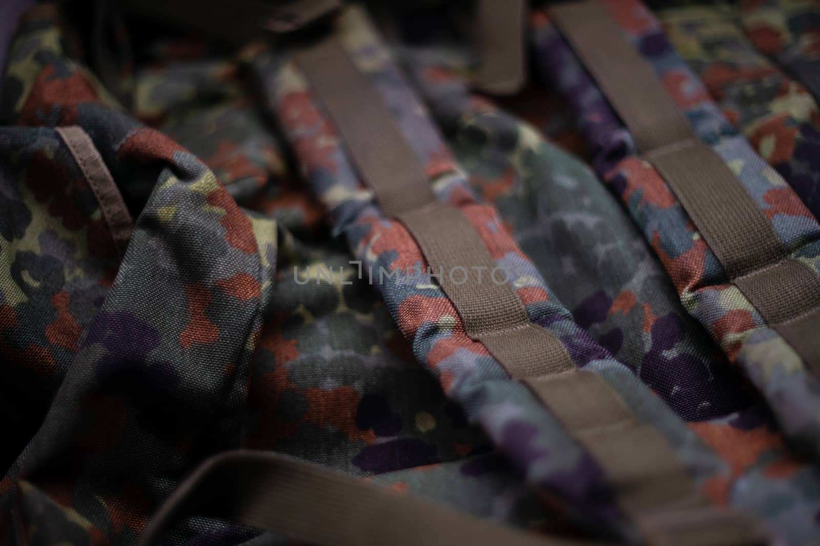 Military camouflage roomy backpack. In the frame of the strap and the back of a backpack. Close-up view.