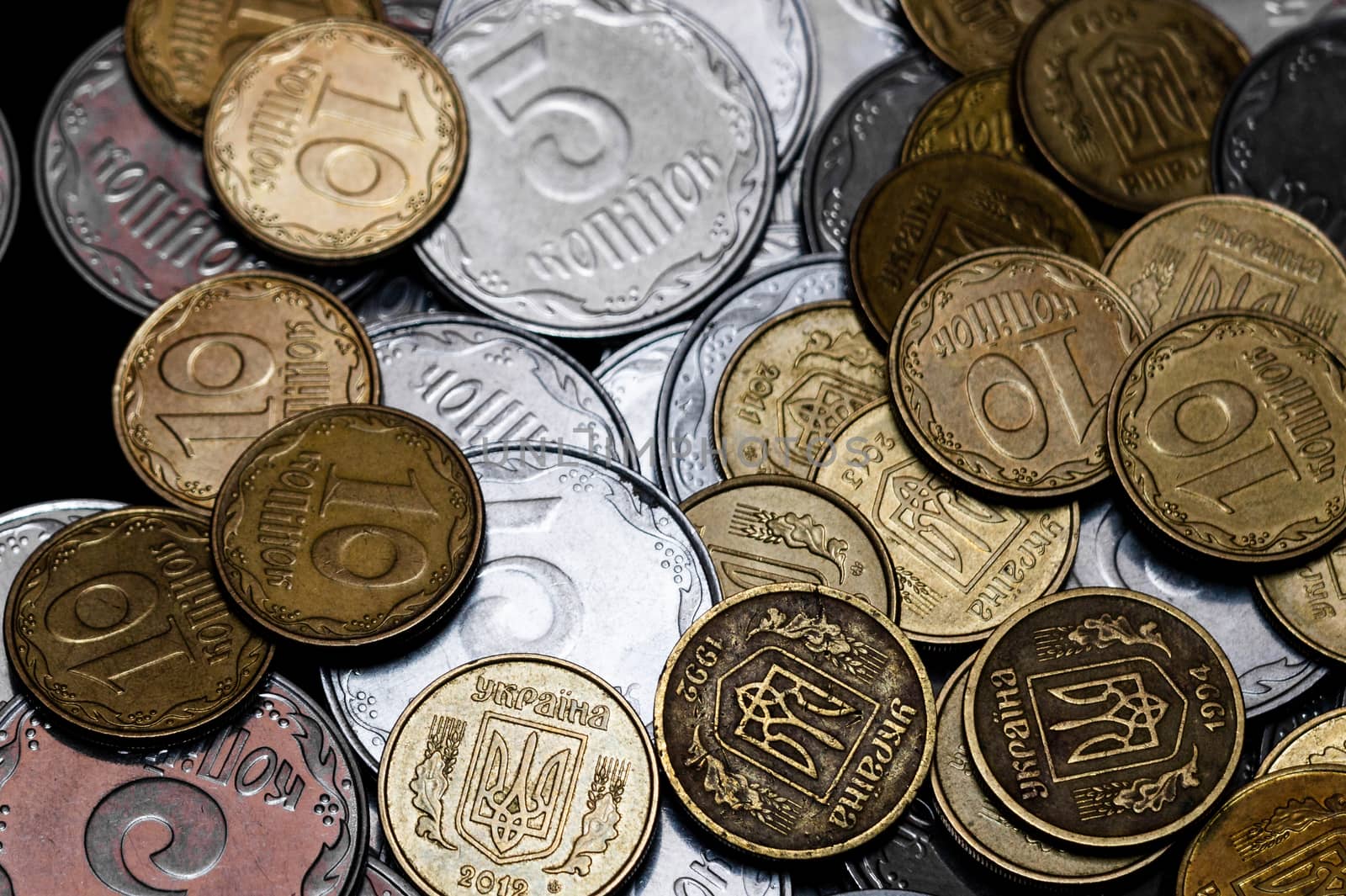 Ukrainian coins isolated on black background. Close-up view. Coins are located in the center of frame. A conceptual image.
