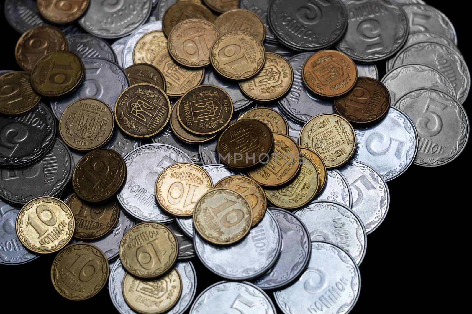 Ukrainian coins isolated on black background. Close-up view. Coins are located in the center of frame. A conceptual image.