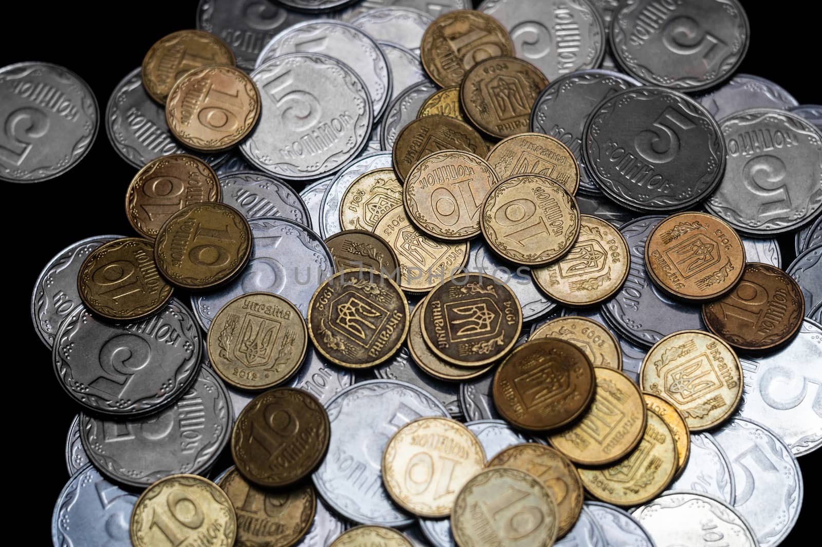 Ukrainian coins isolated on black background. Close-up view. Coins are located in the center of frame. A conceptual image.