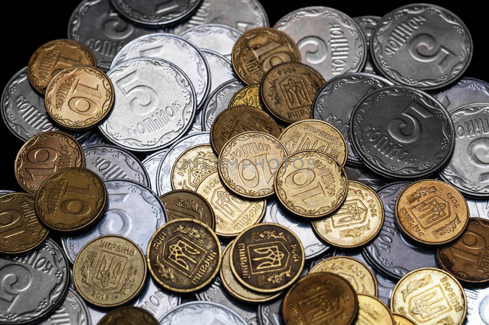 Ukrainian coins isolated on black background. Close-up view. Coins are located in the center of frame. A conceptual image.