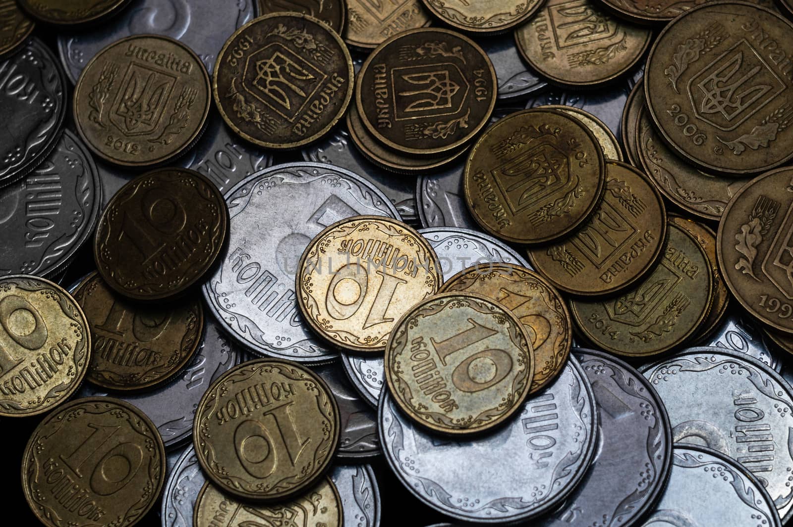 Ukrainian coins isolated on black background. Close-up view. Coins are located in the center of frame. A conceptual image.