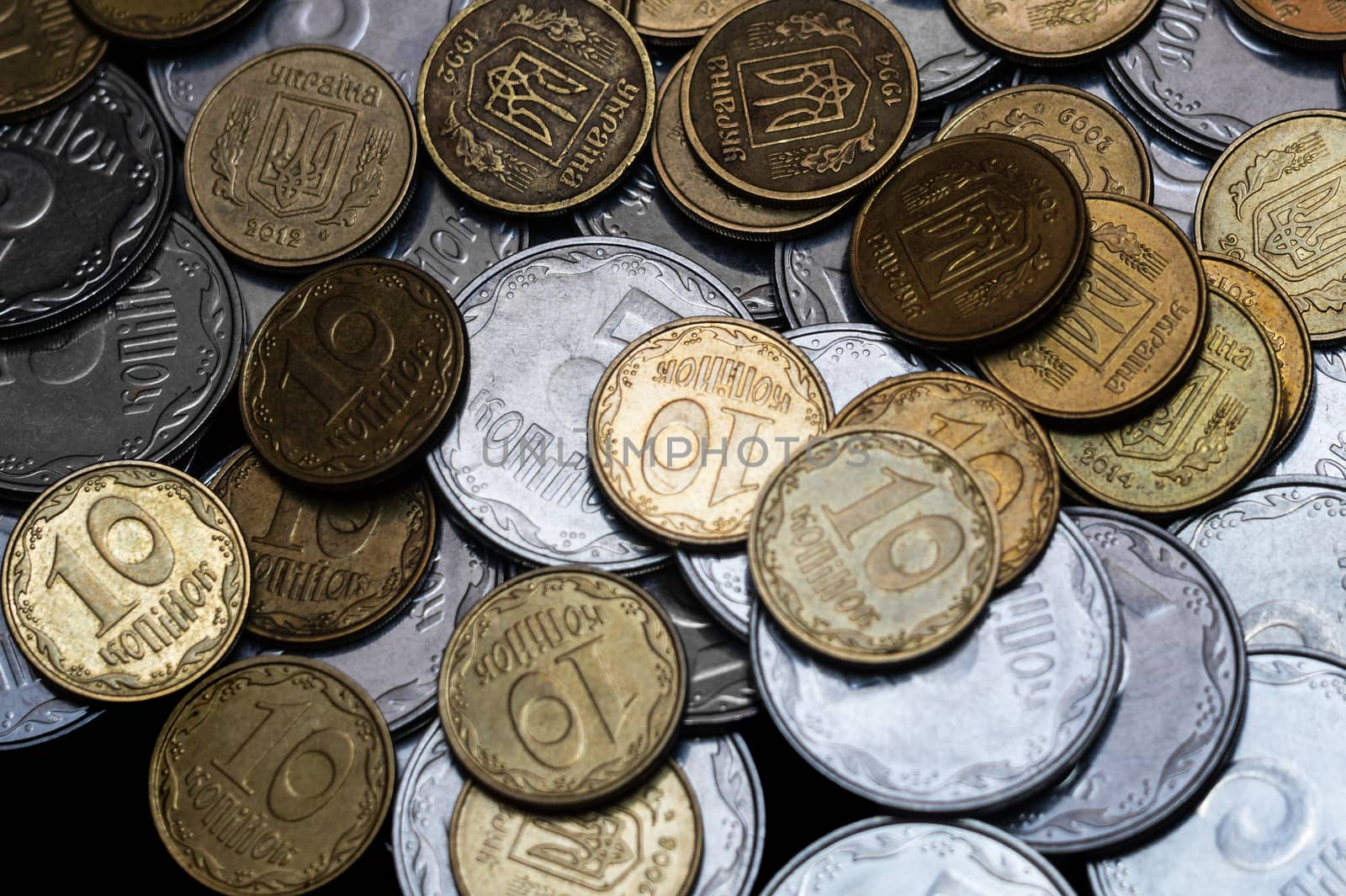 Ukrainian coins isolated on black background. Close-up view. Coins are located in the center of frame. A conceptual image.