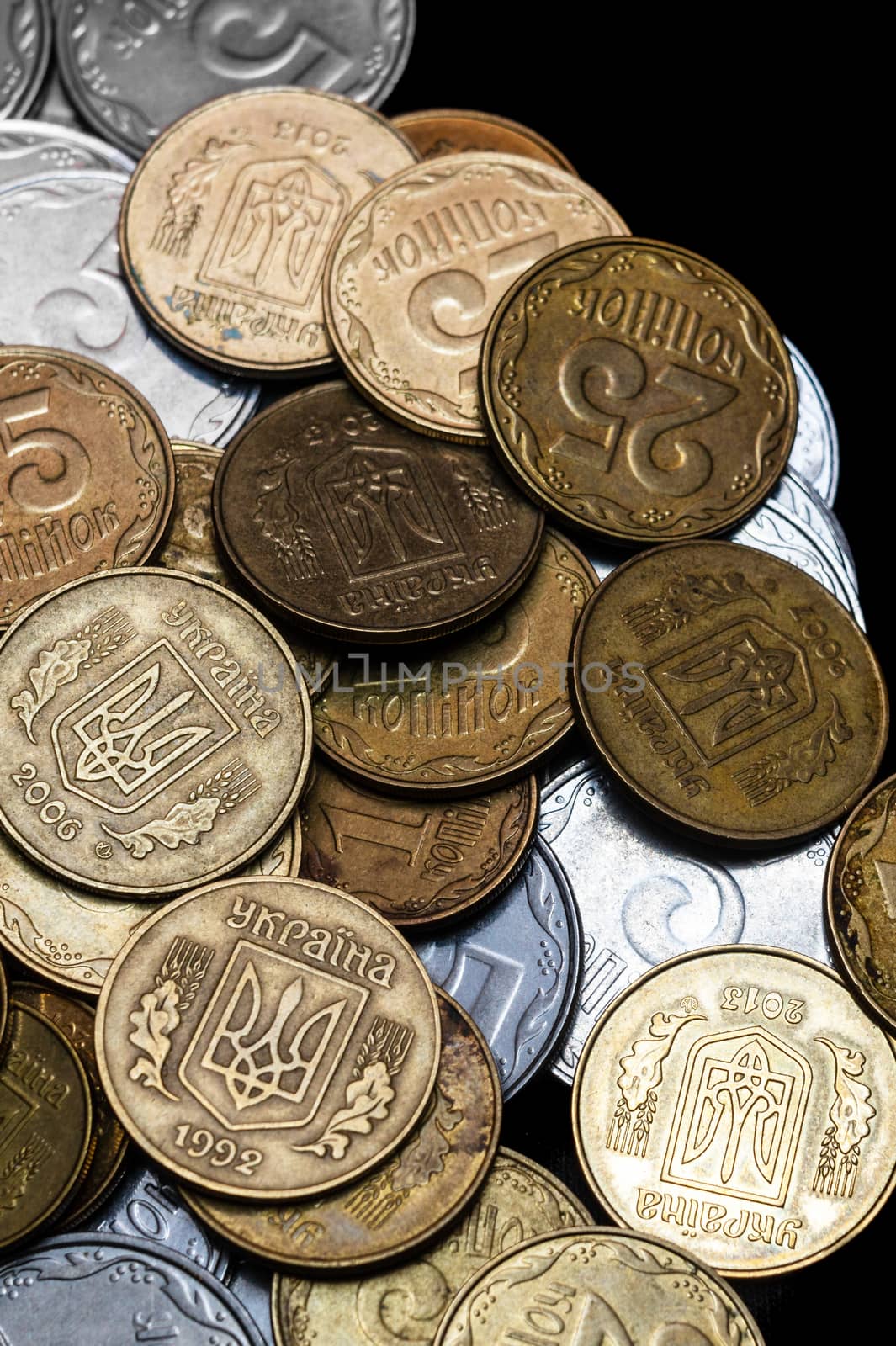 Ukrainian coins isolated on black background. Close-up view. Coins are located in the center of frame. A conceptual image. by alexsdriver