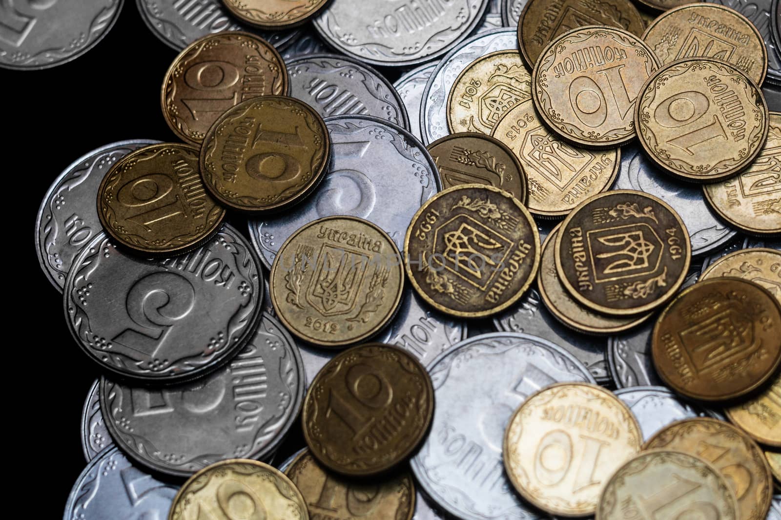 Ukrainian coins isolated on black background. Close-up view. Coins are located in the center of frame. A conceptual image.