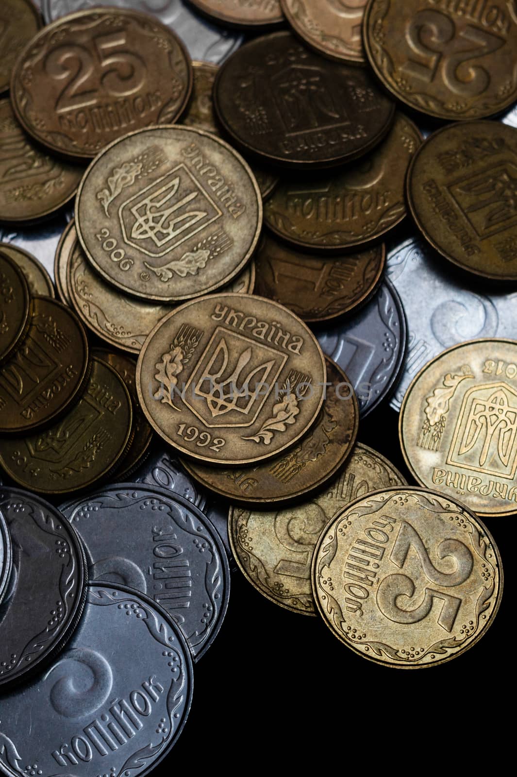 Ukrainian coins isolated on black background. Close-up view. Coins are located above the center of frame. A conceptual image. by alexsdriver