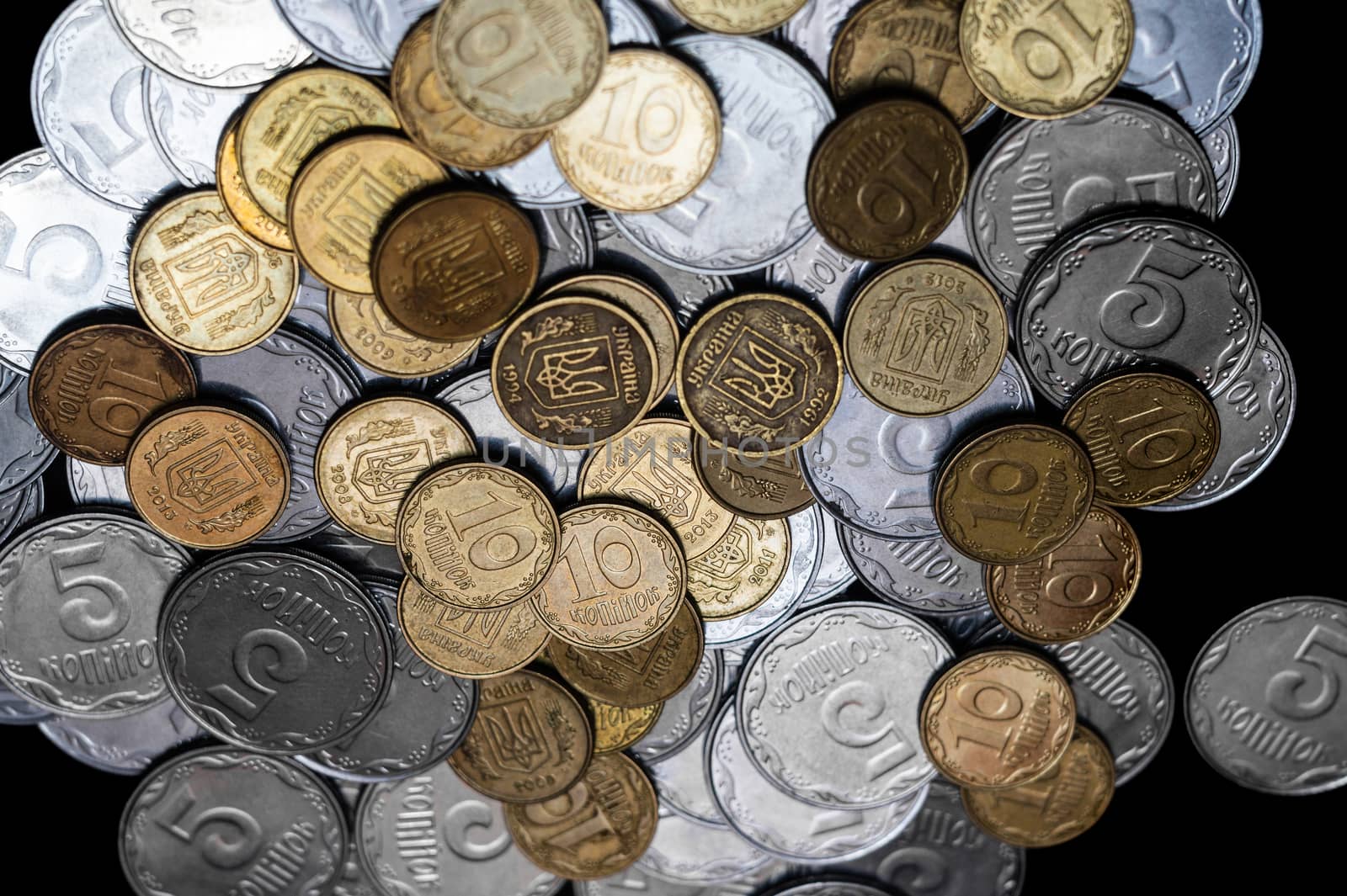 Ukrainian coins isolated on black background. Close-up view. Coins are located in the center of frame. A conceptual image.