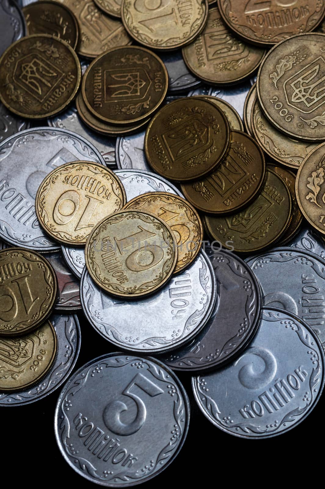 Ukrainian coins isolated on black background. Close-up view. Coins are located in the center of frame. A conceptual image. by alexsdriver