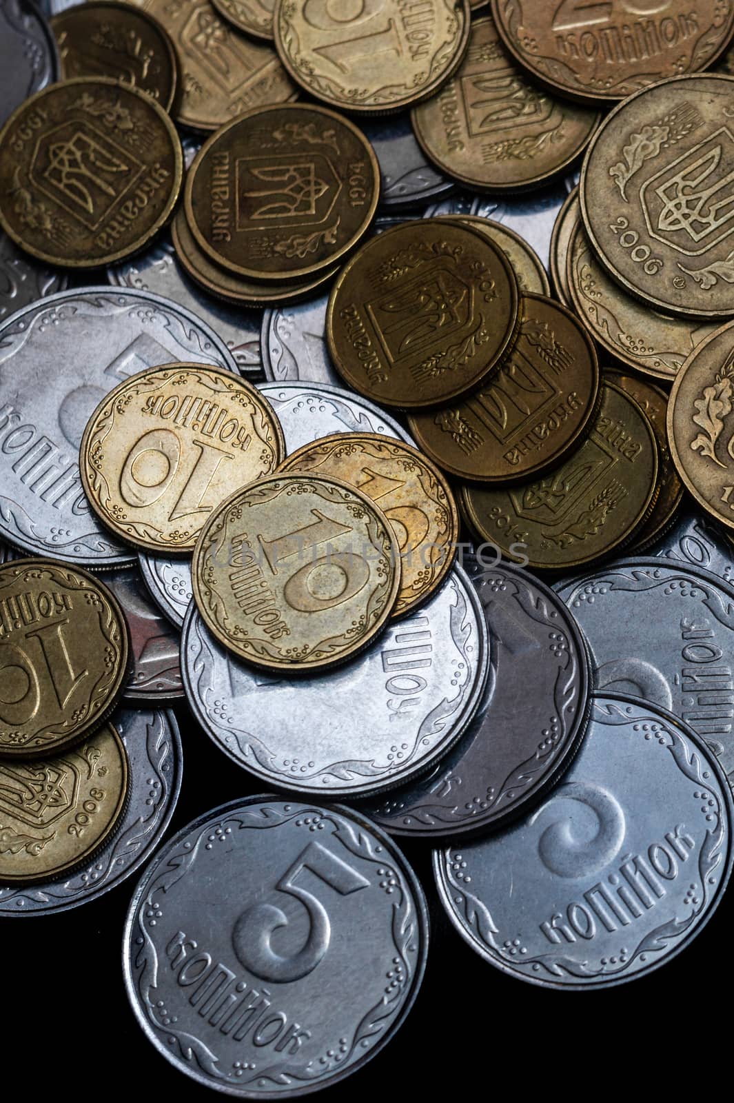 Ukrainian coins isolated on black background. Close-up view. Coins are located in the center of frame. A conceptual image.