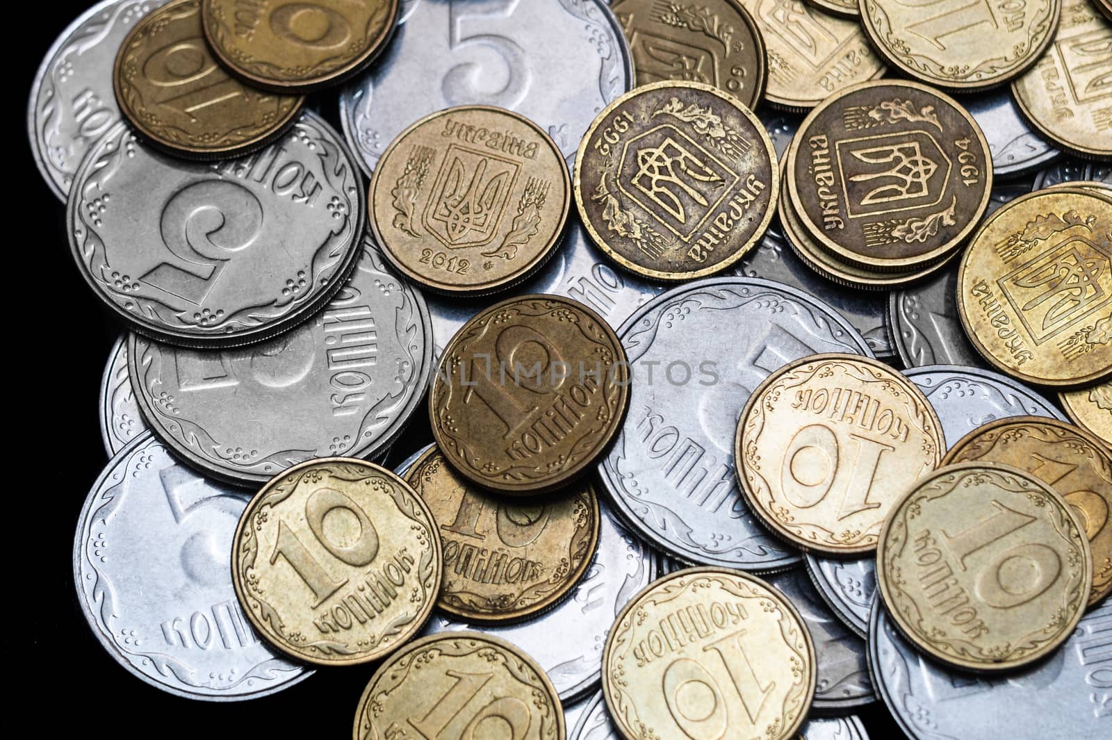 Ukrainian coins isolated on black background. Close-up view. Coins are located in the center of frame. A conceptual image.