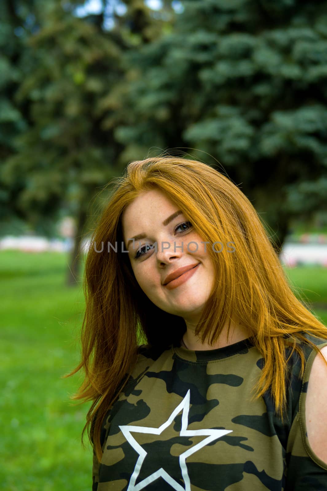 Pretty redhead girl shoot on outdoor park