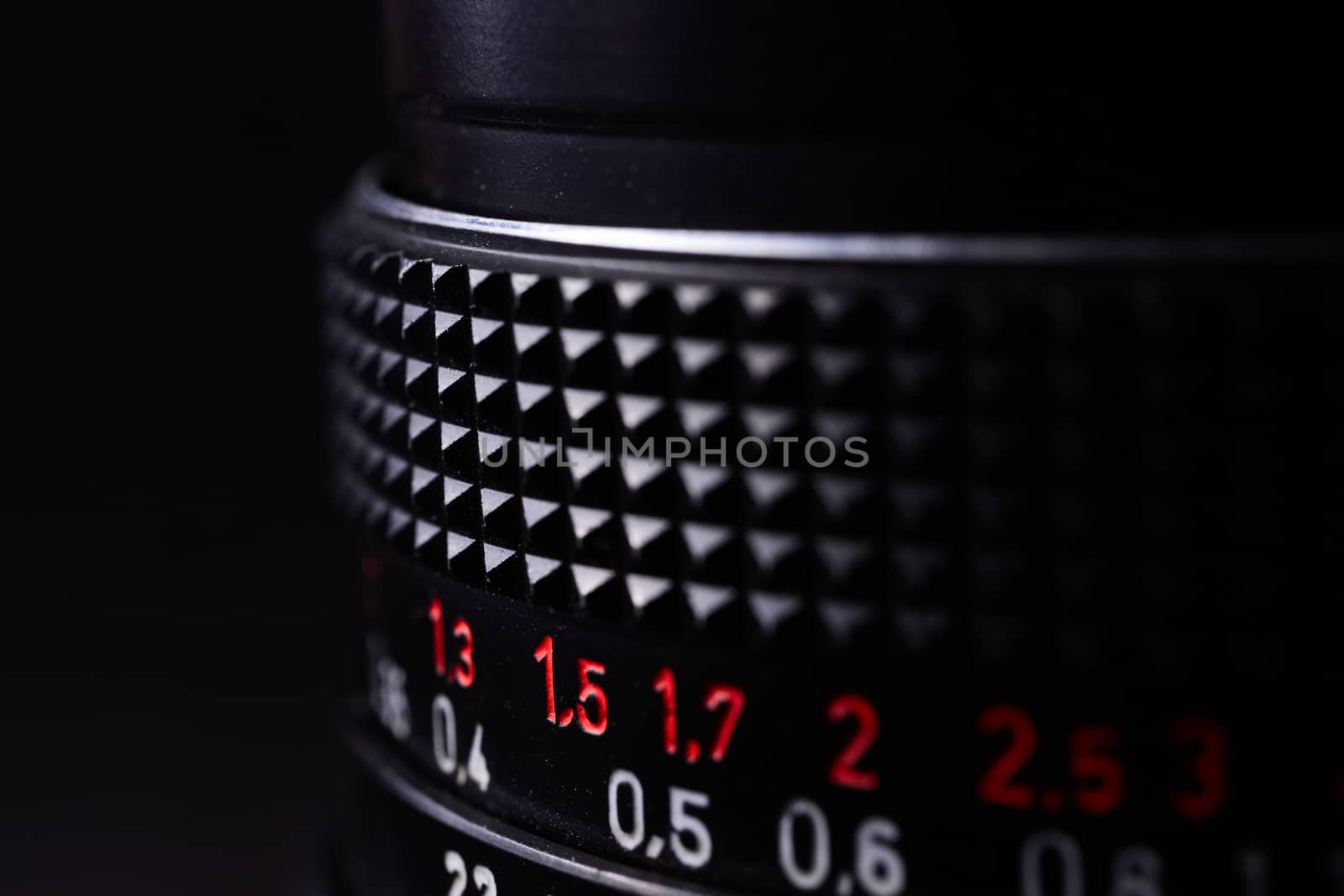 Vintage lens scale signs closeup. Stock photo with blurred gray background.
