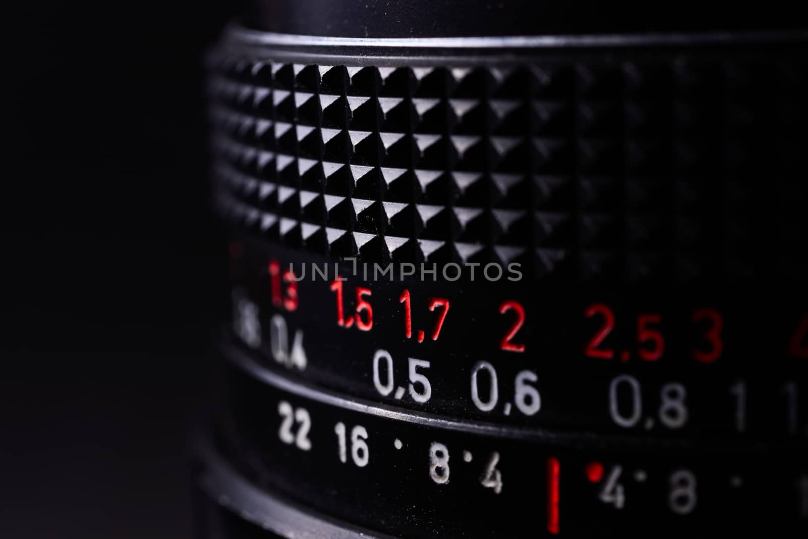 Vintage lens scale signs closeup. Stock photo with blurred gray background.