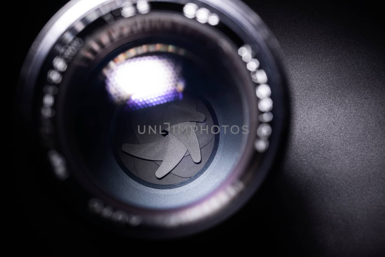 Vintage lens aperture closeup. Stock photo with blurred foreground.
