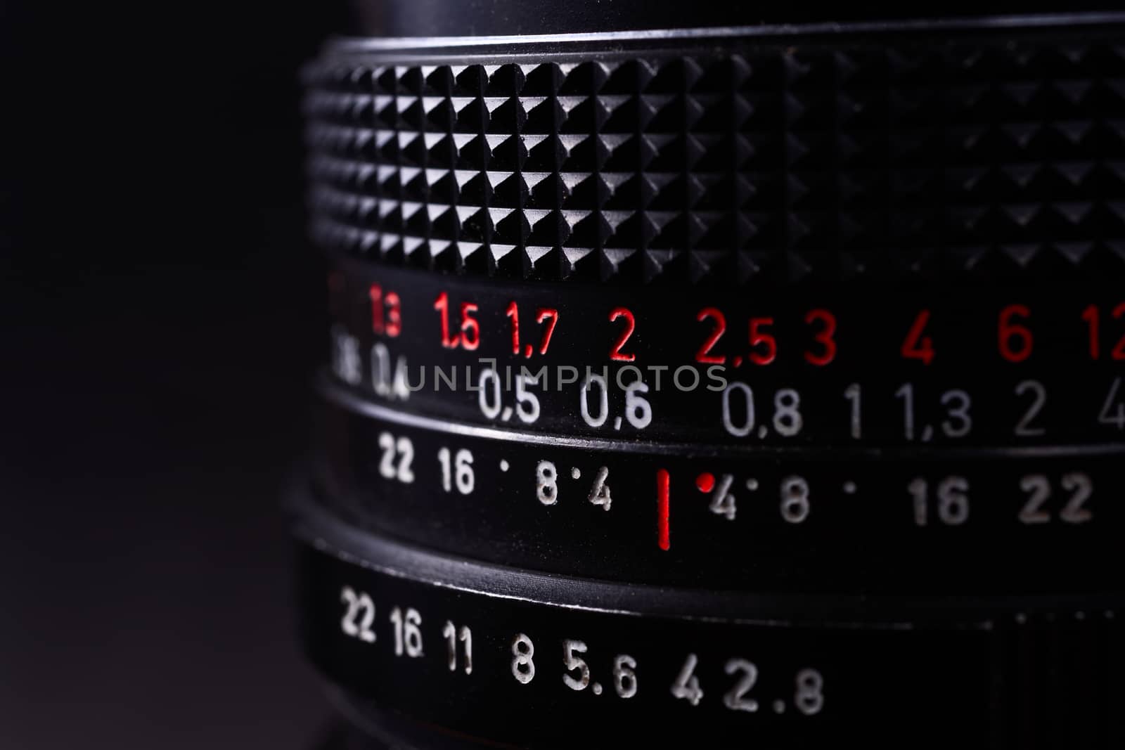 Vintage lens scale signs closeup. Stock photo with blurred gray background.