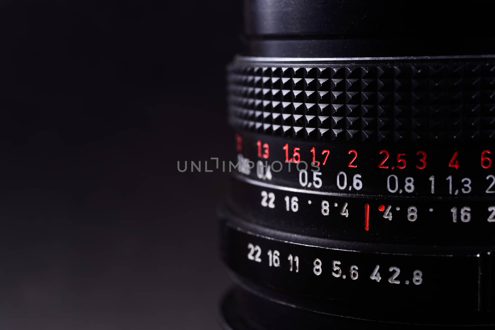 Vintage lens scale signs closeup. Stock photo with blurred gray background.
