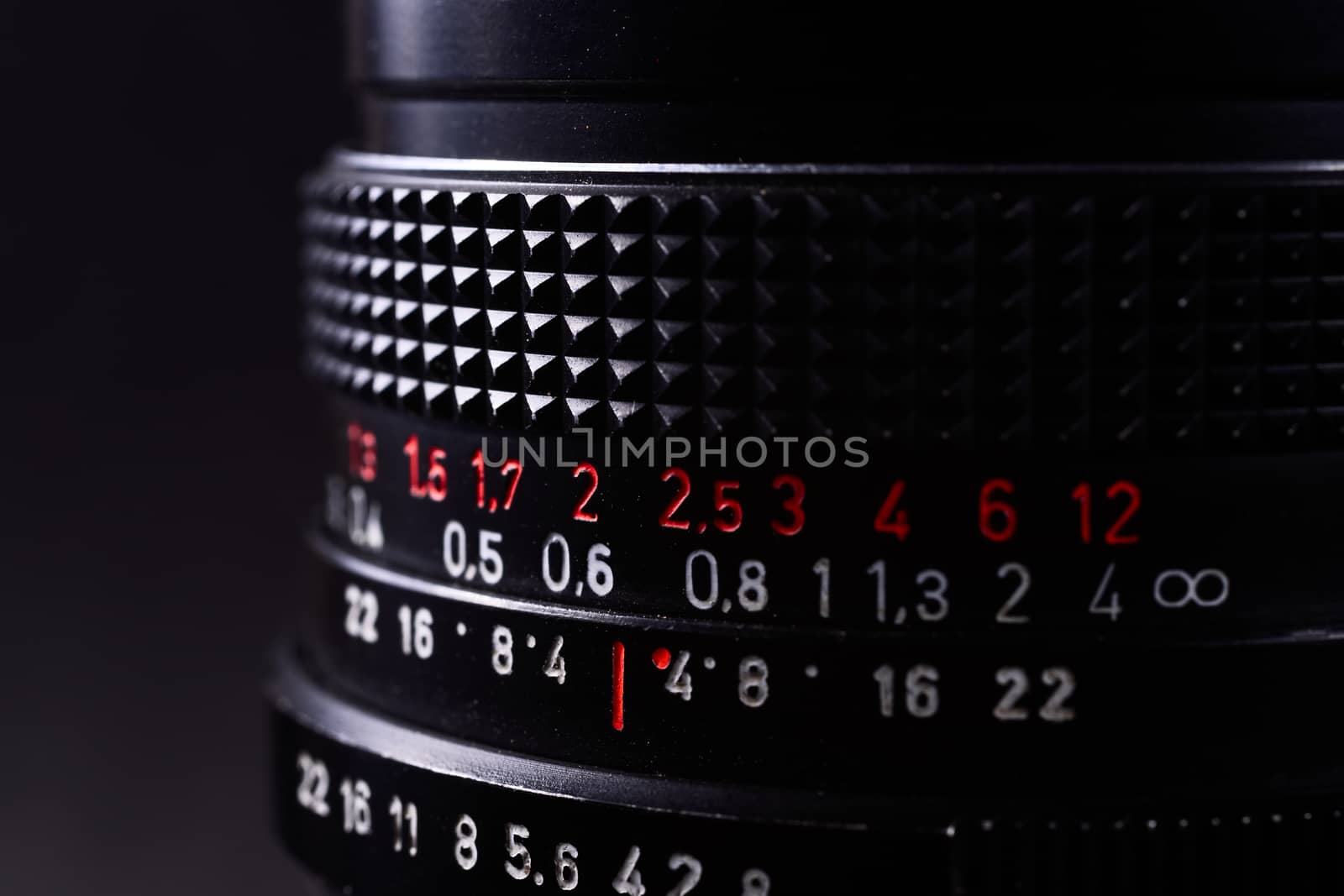 Vintage lens scale signs closeup. Stock photo with blurred gray background.