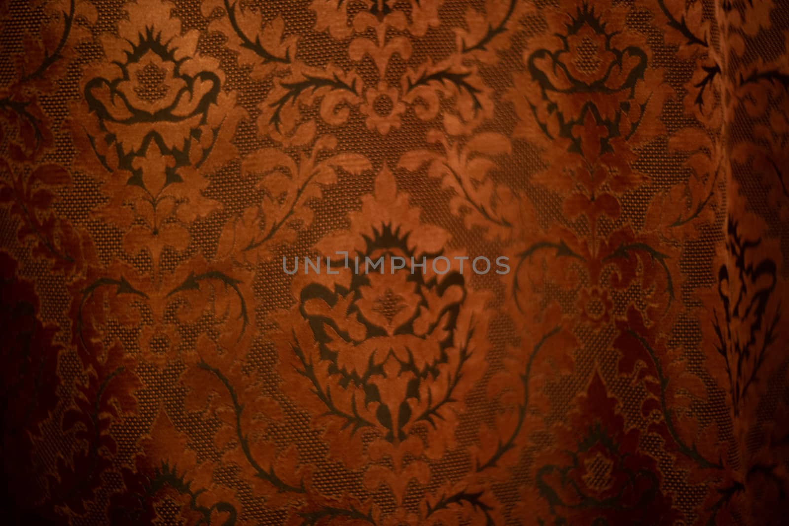 Expensive dark orange home curtains with a very beautiful frilly pattern. Texture shot. Good background or wallpapers.
