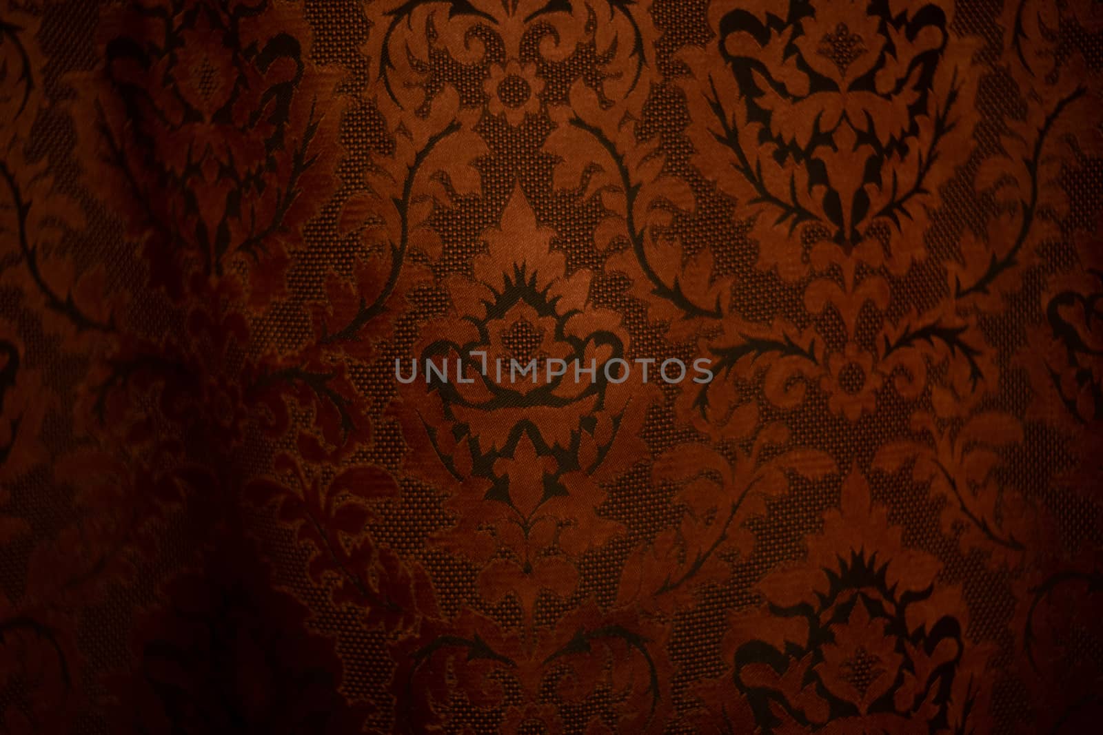 Expensive dark orange home curtains with a very beautiful frilly pattern. Texture shot. Good background or wallpapers.