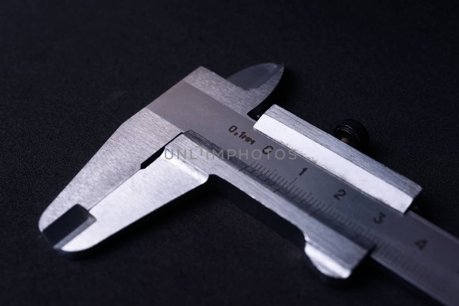 Vintage steel caliper tool closeup. Caliper in very good condition. Scale in metric units, milimeter step. Stock photo isolated on gray background.