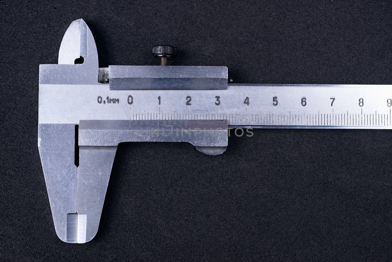 Vintage steel caliper tool closeup. Caliper in very good condition. Scale in metric units, milimeter step. Stock photo isolated on gray background.