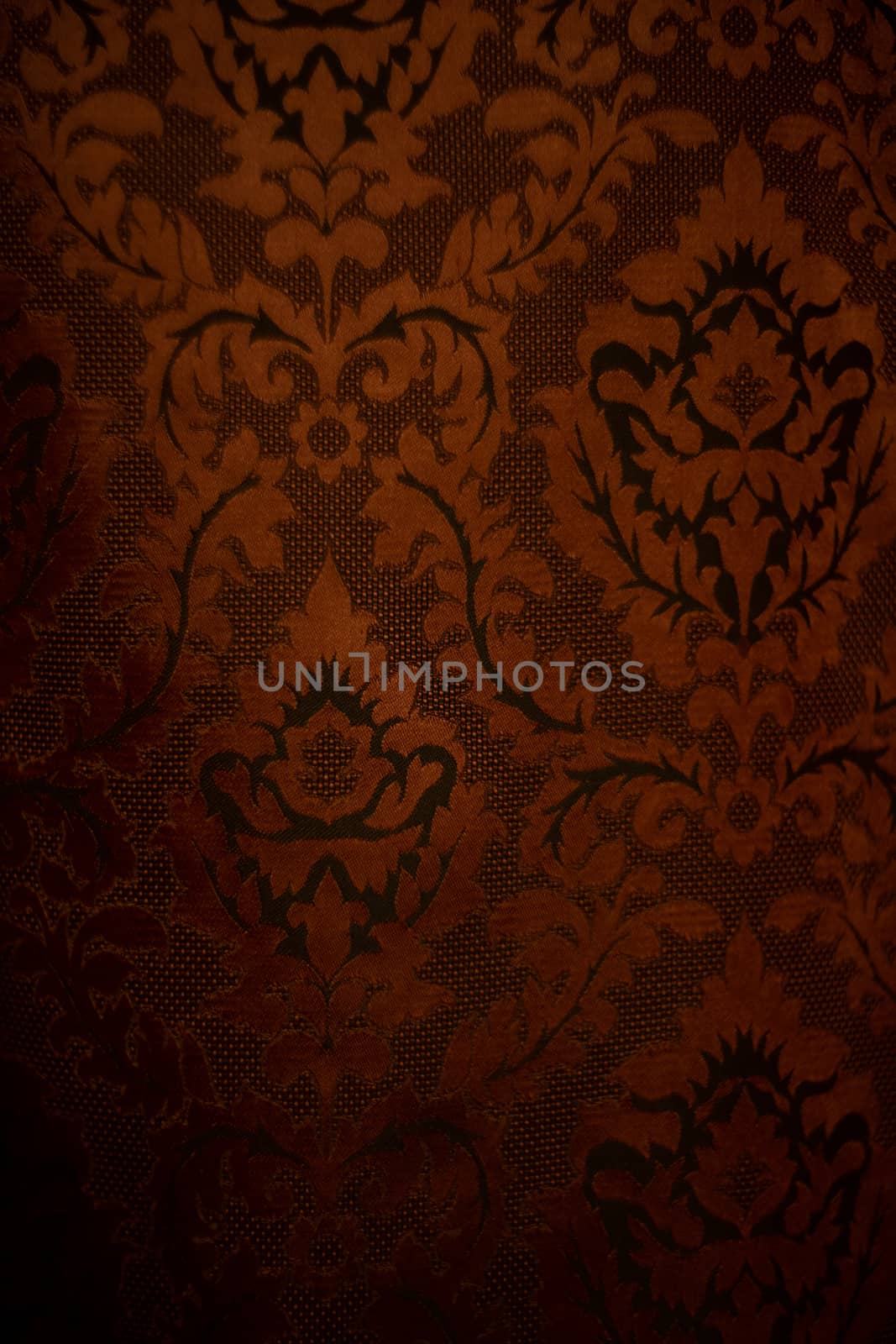 Expensive dark orange home curtains with a very beautiful frilly pattern. Texture shot. Good background or wallpapers.