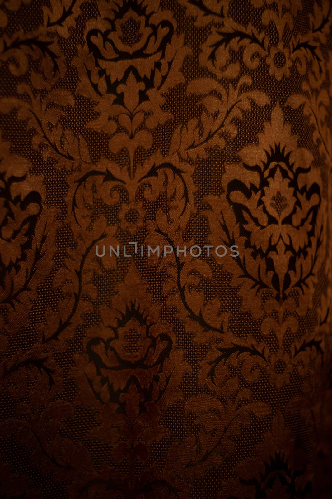 Expensive dark orange home curtains with a very beautiful frilly pattern. Texture shot. Good background or wallpapers.