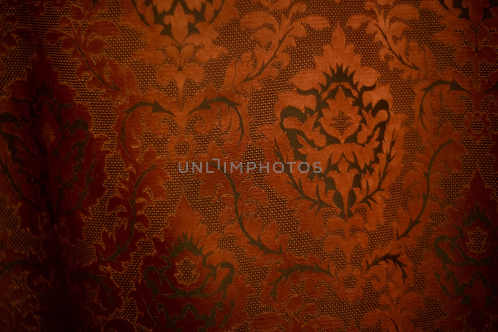 Expensive dark orange home curtains with a very beautiful frilly pattern. Texture shot. Good background or wallpapers.