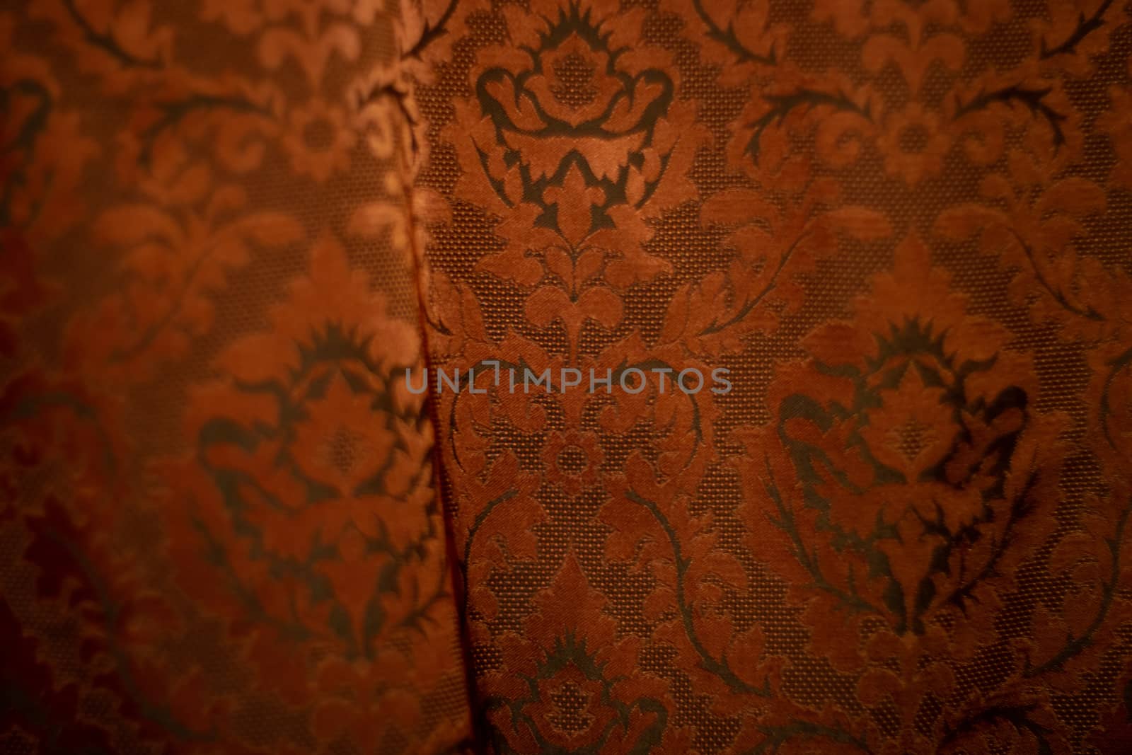 Expensive dark orange home curtains with a very beautiful frilly pattern. Texture shot. Good background or wallpapers.