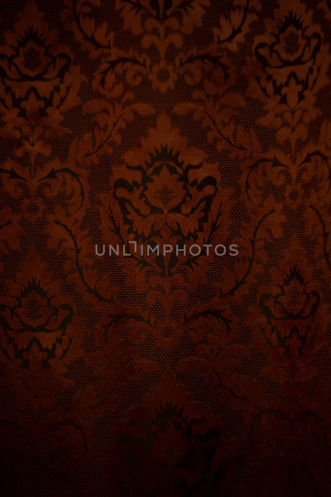 Expensive dark orange home curtains with a very beautiful frilly pattern. Texture shot. Good background or wallpapers.