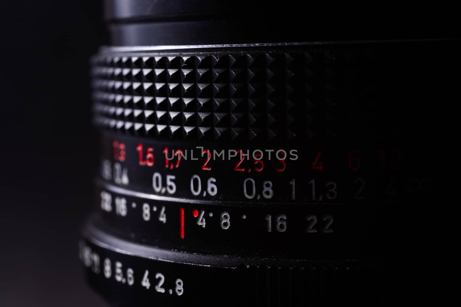 Vintage lens scale signs closeup. Stock photo with blurred gray background.