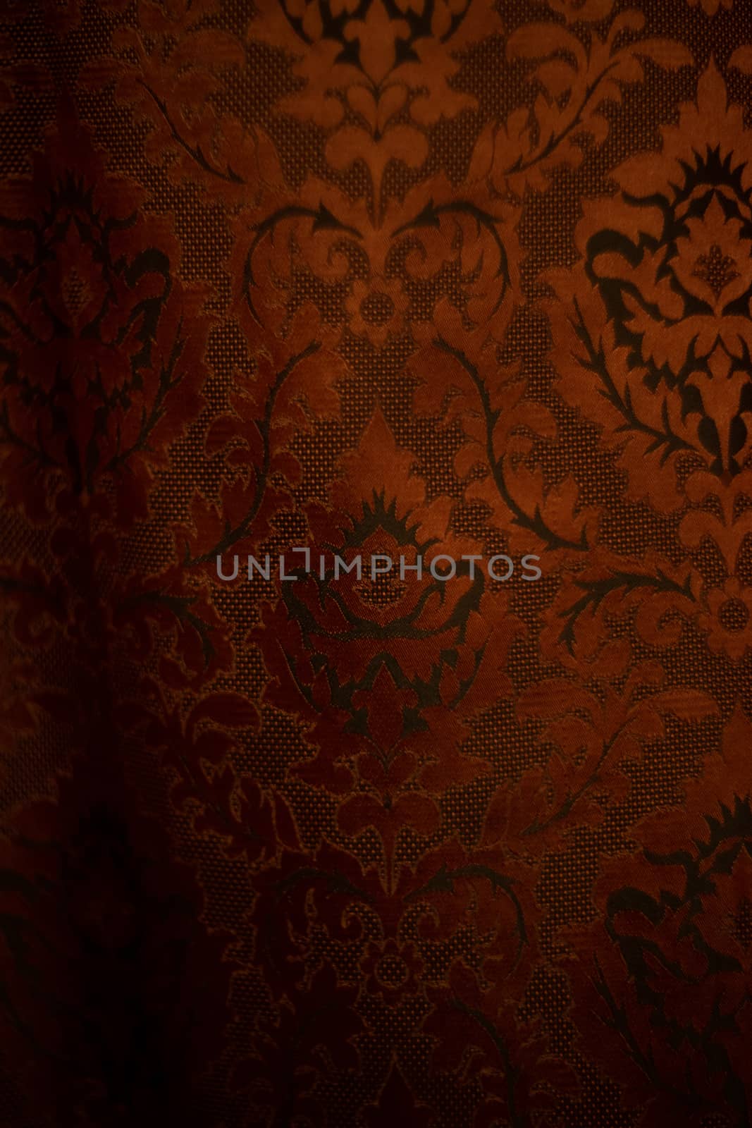 Expensive dark orange home curtains with a very beautiful frilly pattern. Texture shot. Good background or wallpapers.