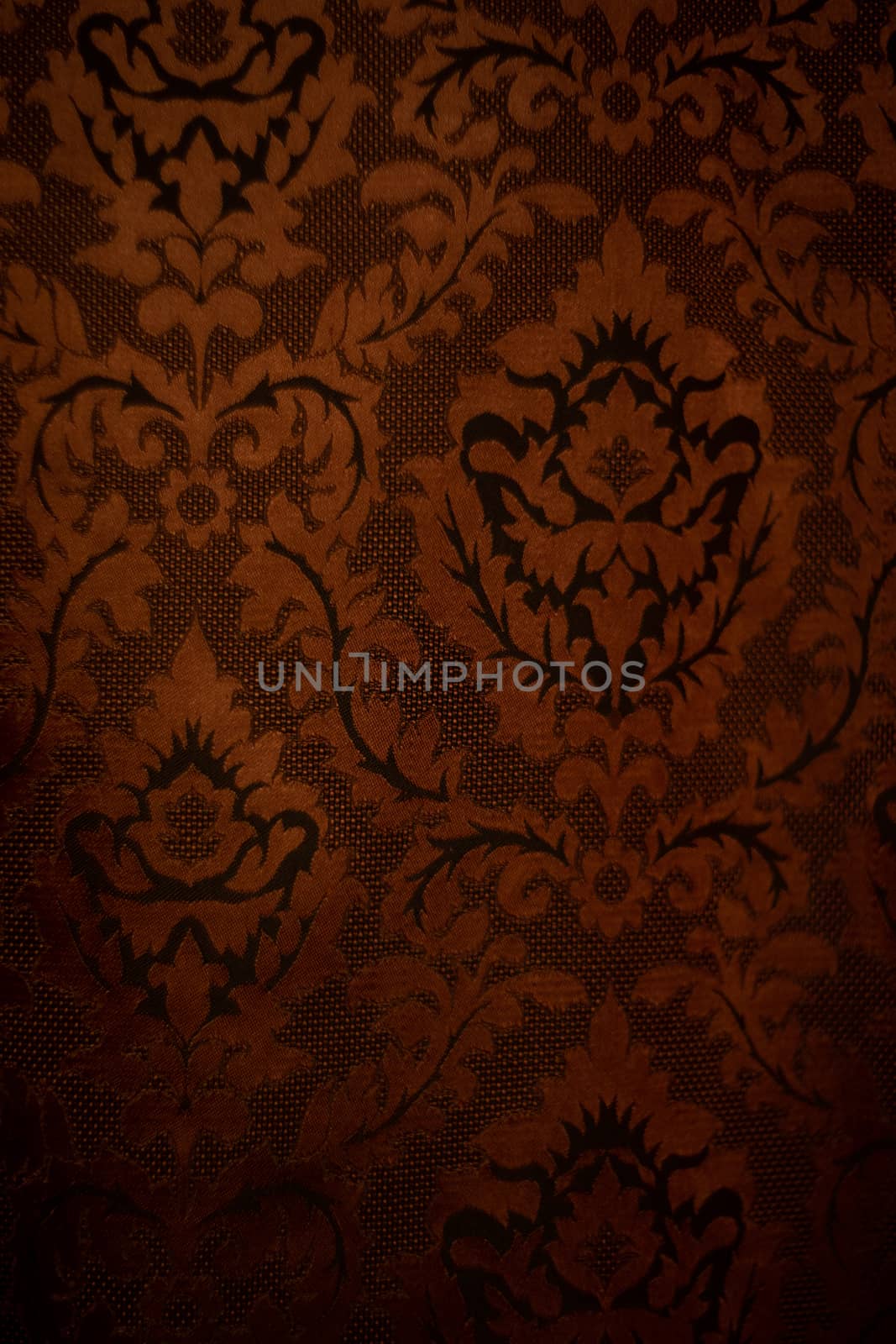 Expensive dark orange home curtains with a very beautiful frilly pattern. Texture shot. Good background or wallpapers.