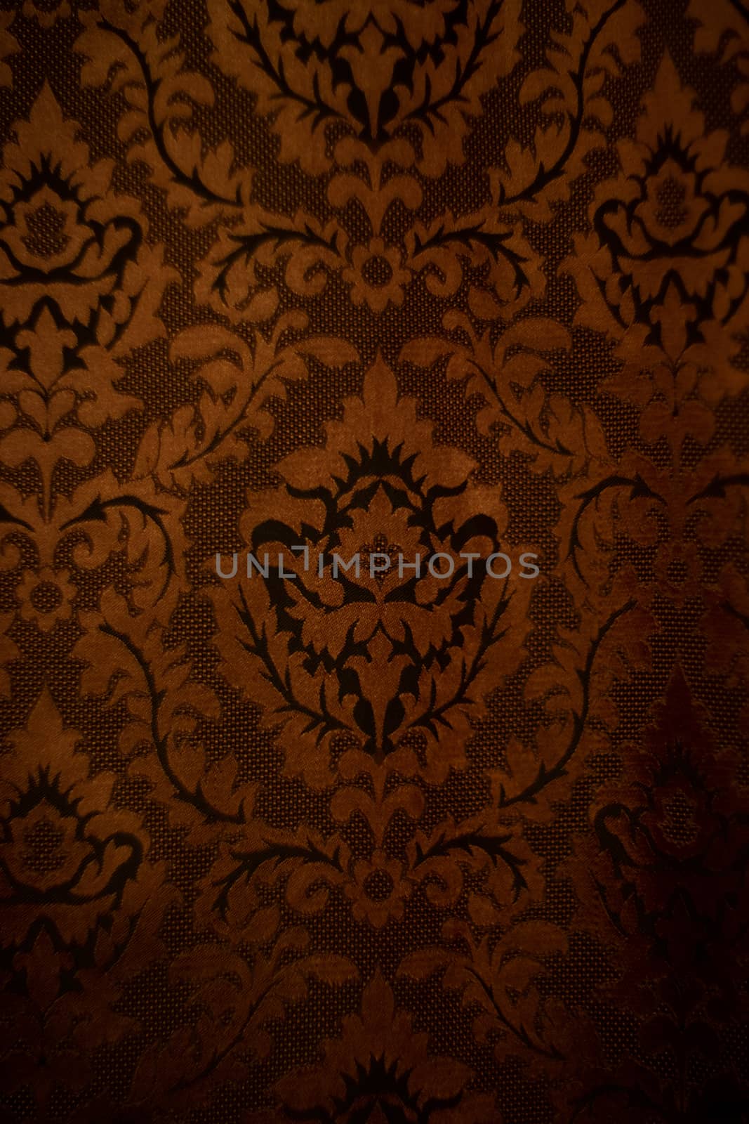 Expensive dark orange home curtains with a very beautiful frilly pattern. Texture shot. Good background or wallpapers.