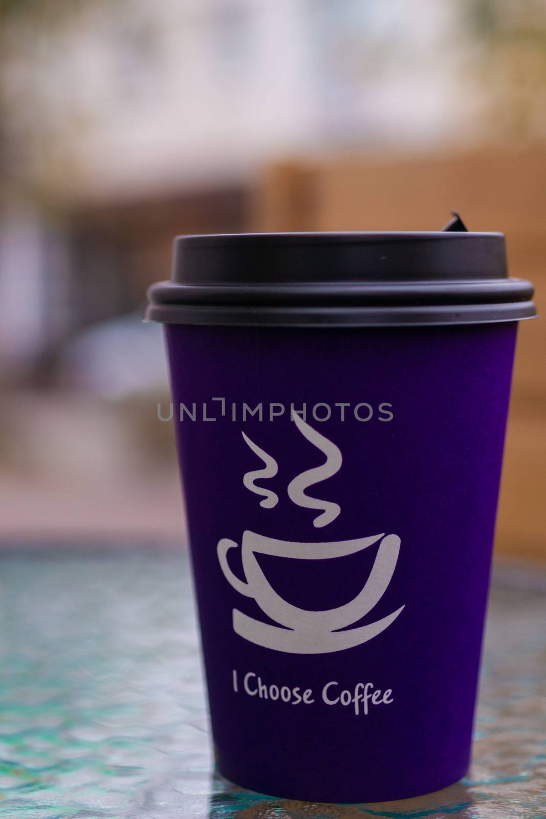 Purple coffee paper cup on glass clear table. On cup wrote: "I choose coffee". Beginning a good day! by alexsdriver