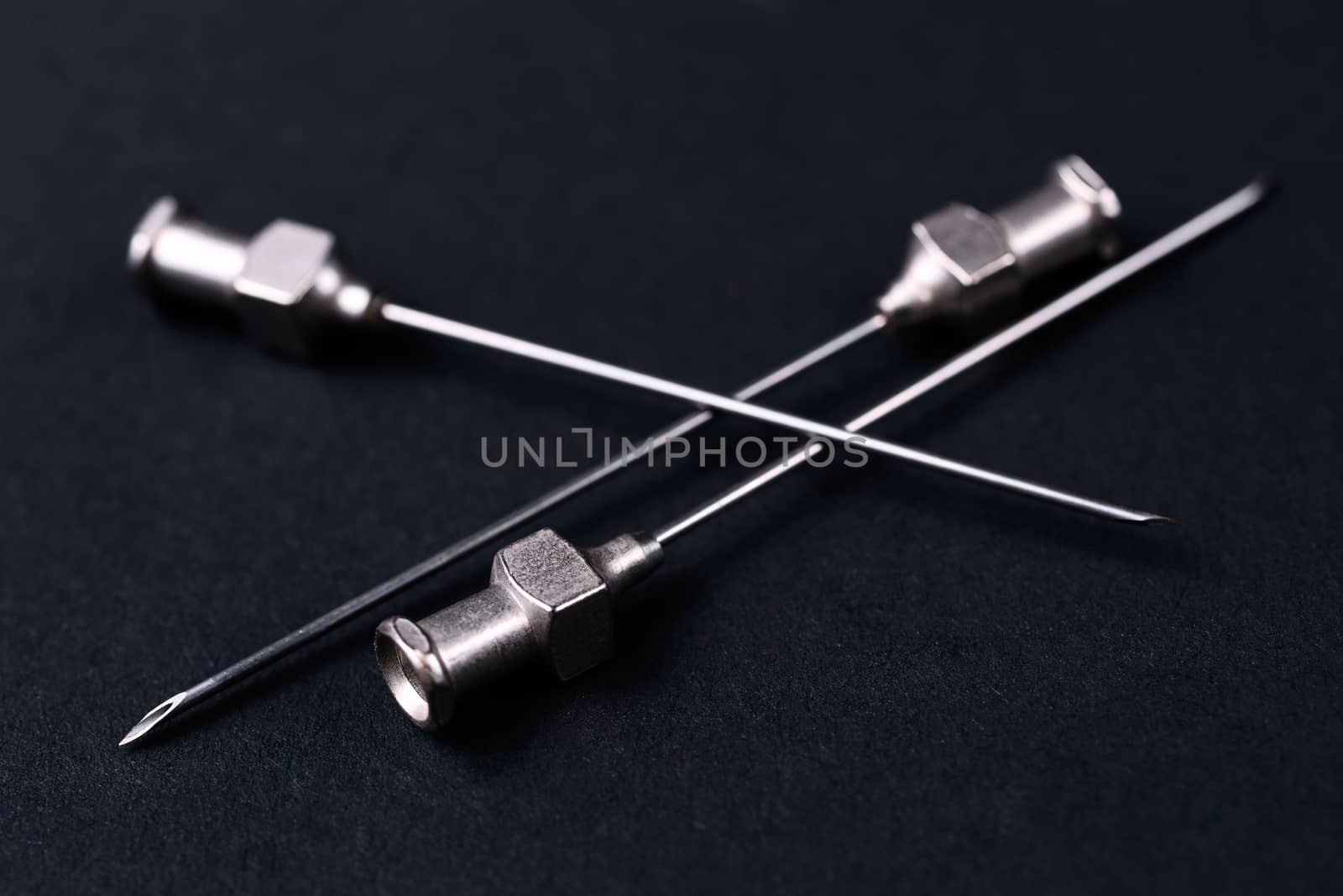Old rare metallic medical needles isolated on gray background. Needles new and clean.